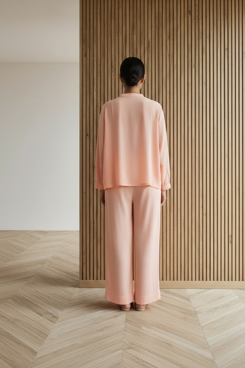 Back pose of the model wearing Fuzzy Peach Loungewear | Organic Cotton | Women